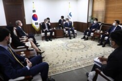 U.S. Special Representative for North Korea, Sung Kim, center left, and South Korean Unification Minister Lee In-young, center right, discuss issues concerning North Korea, at the unification ministry, June 22, 2021, in Seoul, South Korea.