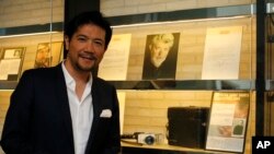 Tetsuya Bessho, a Japanese actor who started a film festival because of his love for short films, poses in front of the display of the Brillia Short Shorts Theater in Yokohama, near Tokyo, Dec. 15, 2015.