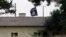 FILE - An Islamic State flag flies over the customs office of Syria's Jarablus border gate as seen from the Turkish town of Karkamis, in Gaziantep province, Turkey, Aug. 1, 2015.