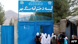 TOPSHOT - Afghan primary school girls arrive for their first class following the start of the new academic year, at a school in Fayzabad district, Badakhshan province on March 20, 2024.