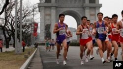 FILE - A crowd of runners passes by the Arch of Triumph in Pyongyang, North Korea during the IAAF-25th Mangyongdae Prize Marathon, April 2012.