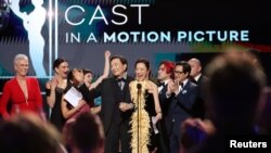 Jamie Lee Curtis, Jenny Slate, Stephanie Hsu, Tallie Medel, James Hong, Andy Le, Michelle Yeoh, Ke Huy Quan, Harry Shum Jr. and Brian Le accept the Outstanding Performance by a Cast in a Film award during the Screen Actors Guild Awards in Los Angeles, California, Feb. 26, 2023. 