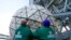 FILE - Workers from Landmark Signs secure a panel of Waterford crystal triangles after installing it on the Times Square New Year's Eve ball, in New York, Dec. 27, 2020.