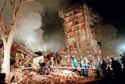 FILE - Rescuers and firefighters work at the site of a massive explosion that destroyed a nine-story apartment building in the southeastern part of Moscow in September 1999.