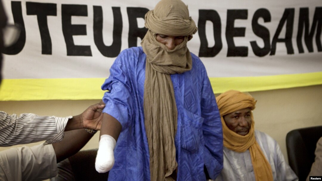 A victim of forced hand amputation by al-Qaida-linked Islamist group Movement for Unity and Jihad under Sharia law as punishment for stealing livestock, Alhader Ag Mahamoud, 30, attends a news conference organized by Amnesty International in Bamako, Mali,