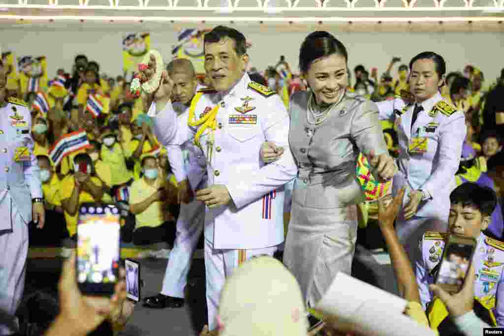 Thailand&#39;s King Maha Vajiralongkorn and Queen Suthida greet royalists at The Grand Palace in Bangkok.