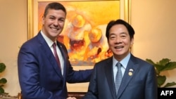 FILE - In this photo released by Santiago Pena's Press Service, Paraguayan President Santiago Pena, left, and Taiwanese then-Vice President Lai Ching-te shake hands during Lai's visit to Paraguay, in Asuncion on Aug. 14, 2023.