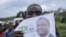 FILE—A supporter of Congolese doctor and presidential candidate Denis Mukwege holds a campaign poster at Kavumu-Bukavu airport, as Mukwege arrives for a campaign rally in Bukavu, capital of South Kivu province, eastern Democratic Republic of Congo, on November 25, 2023.