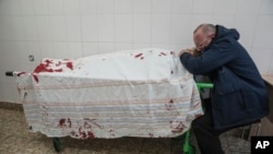 FILE - In a scene in the documentary "20 Days in Mariupol," Serhii, father of teenager Iliya, cries on his son's lifeless body lying on a stretcher at a maternity hospital converted into a medical ward in Mariupol, Ukraine, on March 2, 2022.