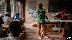 Electoral workers start to count votes at the Lycée Boganda polling station in the capital Bangui, Central African Republic, Dec. 27, 2020.