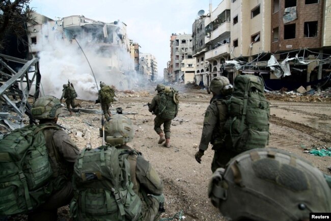 Israeli soldiers operate in the Gaza Strip amid the ongoing conflict between Israel and the Palestinian Islamist group Hamas in this handout picture released by Israel Defense Forces, Dec. 18, 2023.