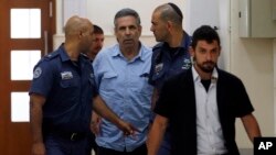 Former Israeli cabinet minister indicted on suspicion of spying for Iran, Gonen Segev, center, is escorted by prison guards as he arrives at court in Jerusalem, Israel, July 5, 2018.