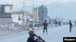 FILE - Afghan National Army soldiers keep watch near the site of a blast in Jalalabad, Afghanistan, Feb. 11, 2021.