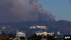 Smoke from the Palisades Fire rises over the Getty Museum in Los Angeles, Jan. 11, 2025.