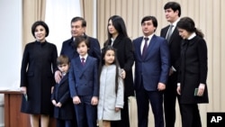 FILE - President Shavkat Mirziyoyev poses with his family after voting during the presidential election, Tashkent, Uzbekistan, Dec. 4, 2016.