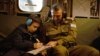 A handout photo provided by the IDF on Nov. 27, 2023, showing Gal Goldstein Almog, an 11-year-old Israeli hostage that was released by Hamas, writing on a board as he returns to the Middle Eastern nation in an IAF helicopter.