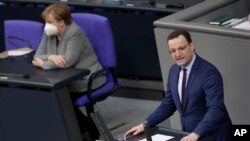 File - Jan. 13, 2021 file photo German Chancellor Angela Merkel and Health Minister Jens Spahn at a meeting of the parliament, Bundestag, in Berlin, that is choosing a new leader on the weekend to succeed Merkel after a 16-year reign.