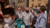  At the Al-Azhar Mosque, worshipers attend Friday prayers for the first time in more than five months, after getting their temperature checked, Aug. 28, 2020 in Cairo. (Hamada Elrasam/VOA)