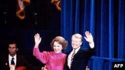 FILE -— US President Jimmy Carter and First Lady Rosalynn Carter wave to the crowd during the Democratic National Convention at Madison Square in New-York on August 13, 1980.