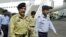 FILE - Lt. General Shahid Aziz (foreground, left) walks with military officials at Allama Iqbal International Airport in Lahore, Pakistan, March 25, 2004.