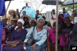 FILE—Family members attend the burial of Moreblessing Ali, on the outskirts of Harare, March, 2, 2024.