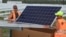 FILE - Workers install solar panels at the Constantine photovoltaic power station in Cestas, near Bordeaux, southwestern France.