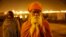 A Hindu holy man stands at Sangam, the confluence of the rivers Ganges, Yamuna and the mythical Saraswati during the annual traditional fair of Magh Mela, in Allahabad, India, Feb. 14, 2014.