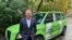 FILE - Showing an example of the purpose of "green hydrogen," Australian mining billionaire Andrew Forrest poses in front of a taxi promoting green hydrogen clean energy alternatives, in London, Oct. 25, 2021.