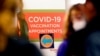 A COVID-19 vaccination appointments sign points the way at Edward Hospital in Naperville, Ill., Dec. 17, 2020.