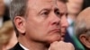 FILE - U.S. Supreme Court Chief Justice John Roberts listens as President Donald Trump delivers his first State of the Union address in the House chamber of the U.S. Capitol in Washington, Jan. 30, 2018.