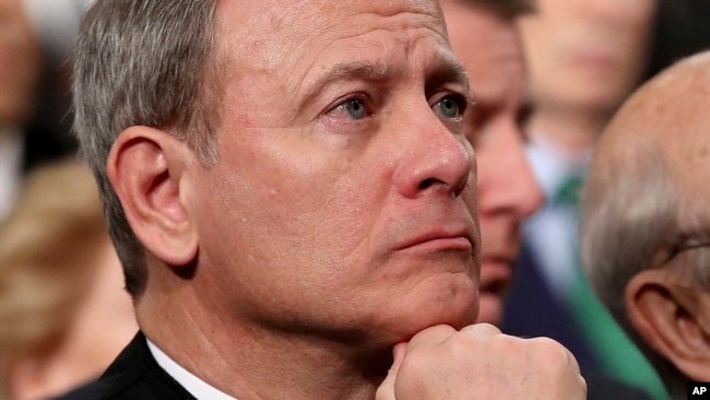 FILE - U.S. Supreme Court Chief Justice John Roberts listens as then-President Donald Trump delivers his first State of the Union address in the House chamber of the U.S. Capitol in Washington, Jan. 30, 2018.