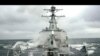 FILE - Sea spray whips across deck of USS Winston Churchill guided missile destroyer (DDG 81).