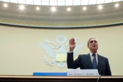 FILE - Former special counsel Robert Mueller is sworn in before the House Intelligence Committee to testify on his report on Russian election interference, on Capitol Hill, July 24, 2019, in Washington.