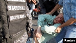 Teodoro Campos, opposition lawmaker and security chief of Venezuelan presidential candidate Henri Falcon, receives help after sustaining injury during a rally with Falcon, in Caracas, Venezuela, April 2, 2018.