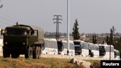 Buses carrying rebels, who were evacuated from Rastan, are seen in Homs countryside, Syria, May 7, 2018. 