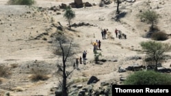 FILE PHOTO: Ethiopians fleeing from the Tigray region violence walk towards river to cross from Ethiopia to Sudan.