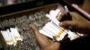 An employee counts cigarettes before packing them in Sidoarjo, Indonesia's East Java province April 7, 2010. 