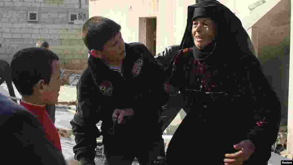 A woman reacts after what activists said was shelling from forces loyal to Syria&#39;s President Bashar al-Assad in Al-Atareb, Aleppo countryside, Feb. 16, 2014.