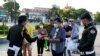 FILE PHOTO - Military police officers hand out free face masks to people, amid concerns over a spread of the Covid-19 coronavirus at a park in Phnom Penh on November 12, 2020. (Photo by TANG CHHIN Sothy/AFP)