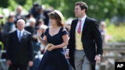 FILE - In this May 20, 2017 file photo, Britain's Princess Eugenie and her partner Jack Brooksbank arrive for the wedding of Pippa Middleton and James Matthews at St Mark's Church in Englefield, England. 