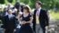FILE - In this May 20, 2017 file photo, Britain's Princess Eugenie and her partner Jack Brooksbank arrive for the wedding of Pippa Middleton and James Matthews at St Mark's Church in Englefield, England. 