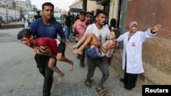People carry Palestinian children wounded in an Israeli strike, amid Israel-Hamas conflict, at Nasser hospital, in Khan Younis in the southern Gaza Strip July 22, 2024.