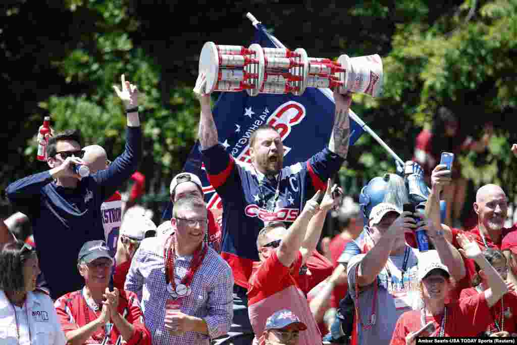 Washington Capitals fans cheer from the bus ridding in the Stanley Cup championship parade and celebration on Constitution Avenue.