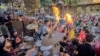 After finishing the prayers of Eid Al-Adha, young Egyptians gather for big streets dancing parties with DJ sound system and drums, in Old Cairo. (H. Elrasam/VOA)