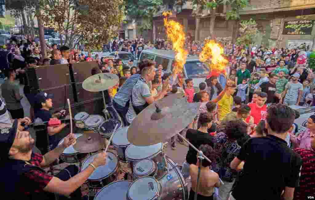 After finishing the prayers of Eid Al-Adha, young Egyptians gather for big streets dancing parties with DJ sound system and drums,&#160;in Old Cairo.&#160;(H. Elrasam/VOA)