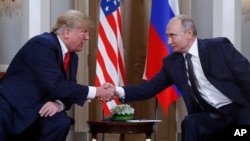 FILE - U.S. President Donald Trump, left, and Russian President Vladimir Putin, right, shake hand at the beginning of a meeting at the Presidential Palace in Helsinki, Finland, July 16, 2018