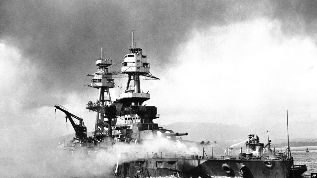 FILE - In this file image provided by the U.S. Navy, crewmen of the USS Nevada fight flames on the battleship, battered in the Japanese aerial attack on Pearl Harbor on Dec. 7, 1941. 