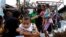 Soldiers help residents as they board a U.S. military C130 aircraft to leave for Manila after Typhoon Haiyan battered Tacloban city in central Philippines, Nov. 11, 2013.