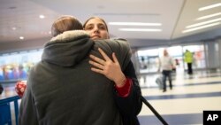 In this Dec. 3, 2019, photo, Mohammed Hafar hugs his daughter Jana after she arrives at JFK Airport in New York, who had been forced by President Donald Trump's travel ban to stay behind in Syria for months. 