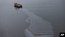 FILE - This aerial view shows a boat leaking oil in the waters near Rio de Janeiro, Brazil. In Seattle, a jury convicted a fisherman of similarly dumping oily pollution into the Pacific Ocean.